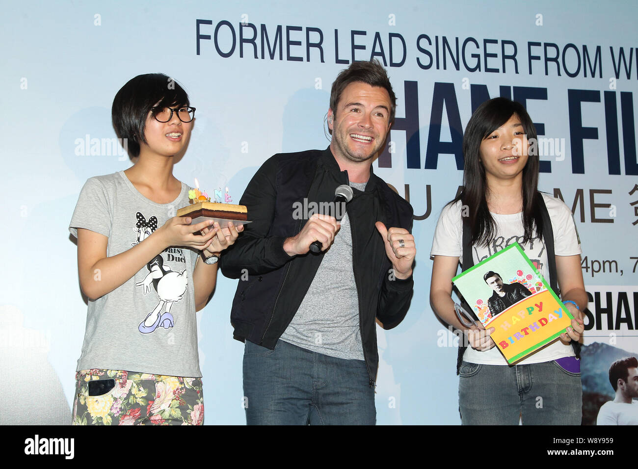 Shane Filan, former lead singer of Irish boy group Westlife, center, poses with fans at a signing event for his new album, You And Me, in Taipei, Taiw Stock Photo