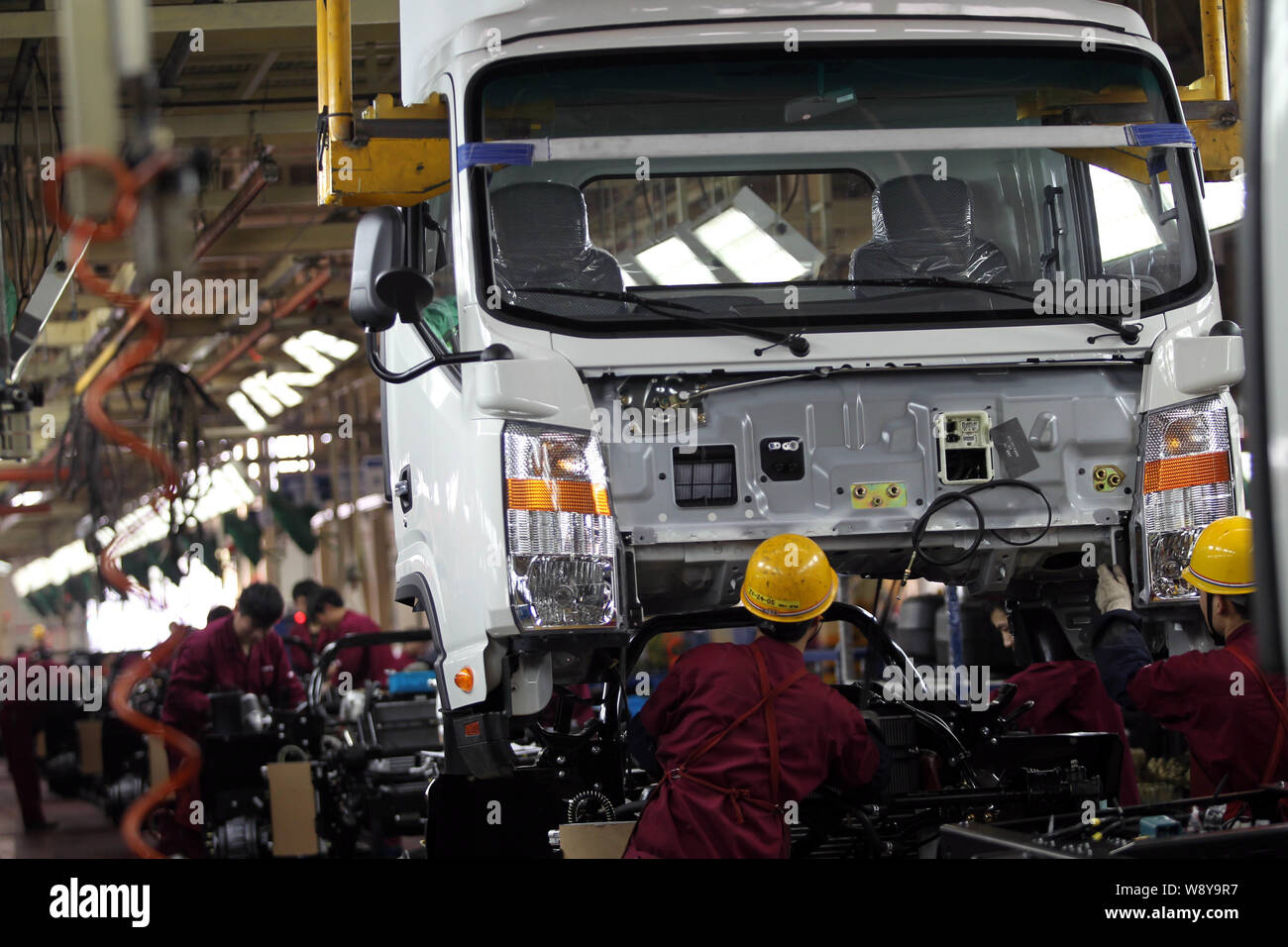 --FILE--Chinese workers assemble trucks on the assembly line at the ...