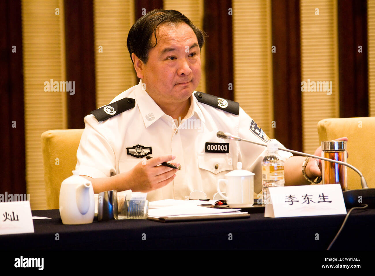 --FILE--Li Dongsheng, then Vice-Minister of Public Security of the Peoples Repulic of China, listens during a meeting in Beijing, China, 19 June 2012. Stock Photo