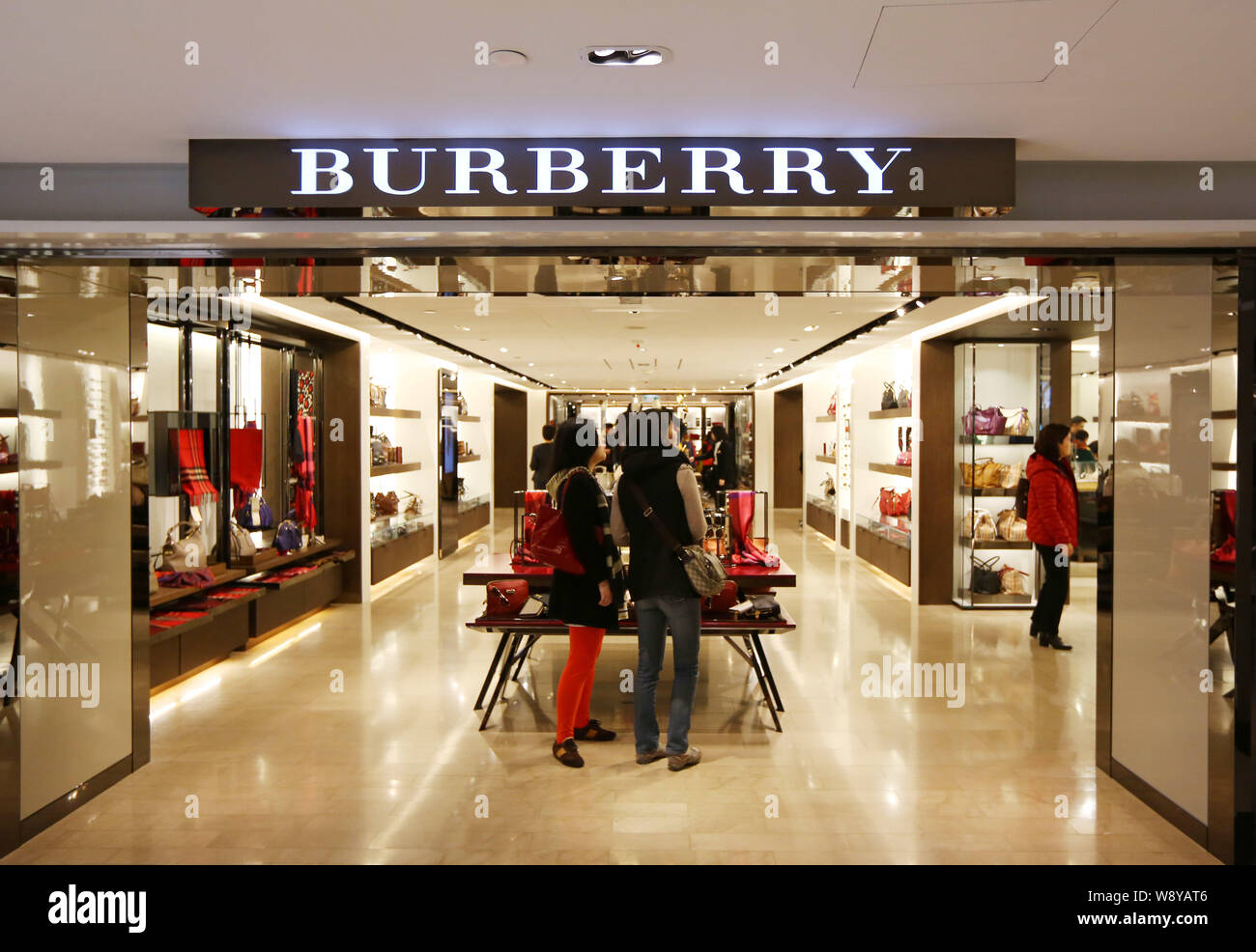 FILE--Customers shop at a Burberry store in Hong Kong, China, 21 December  2013. British fashion house Burberry on April 24 became the first intern  Stock Photo - Alamy