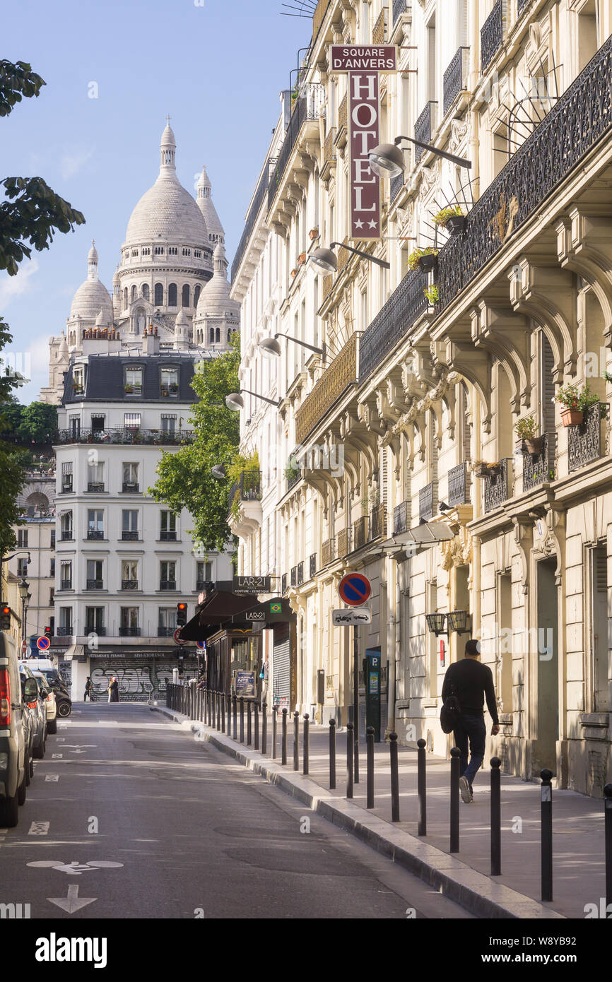 Paris Montmartre street - afternoon sunlight at Place d'Anvers with a view of the Sacre Coeur basilica in Montmartre, Paris, France, Europe. Stock Photo