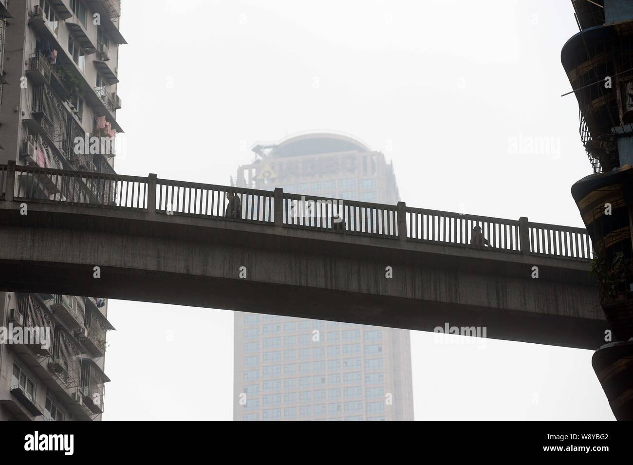 Local Chinese Residents Walk On The Pedestrian Bridge