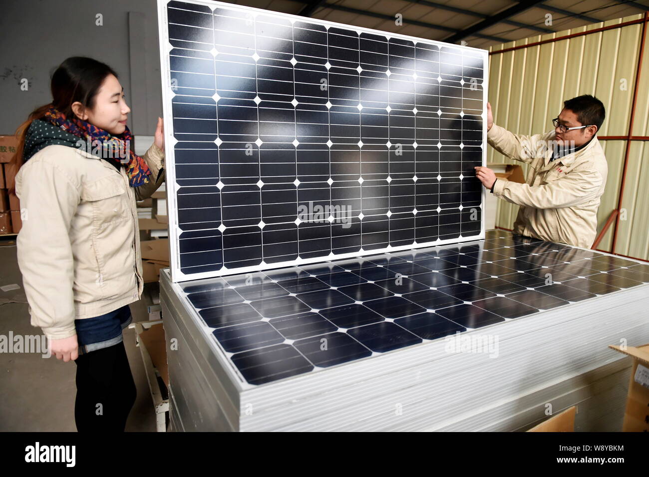 --FILE--Chinese workers check solar panels at the plant of Shandong Hilight -Solar Co., Ltd. in Zouping county, Binzhou city, east China's Shandong pr Stock Photo