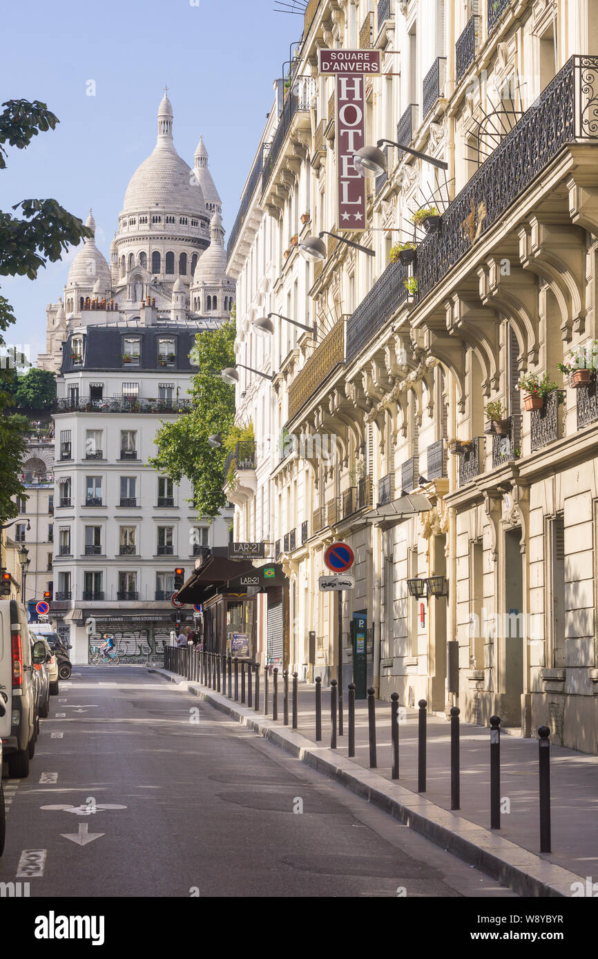 Paris Montmartre street - afternoon sunlight at Place d'Anvers with a view of the Sacre Coeur basilica in Montmartre, Paris, France, Europe. Stock Photo