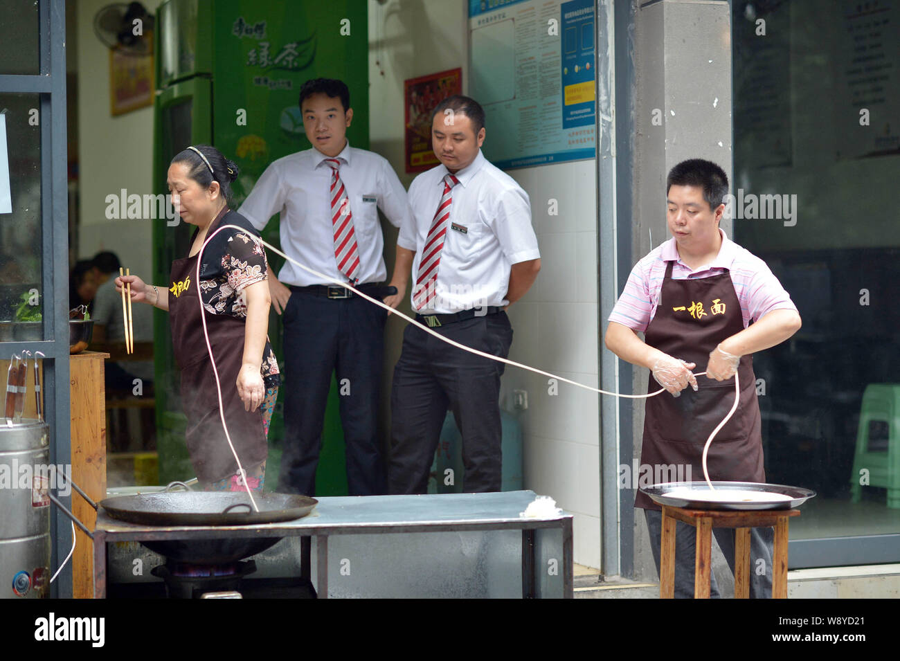 Zhao Mingxi Swings A Long Noodle Into A Hot Pot At His Shop In Chongqing China 15 June 2014 A 32 Year Old Man Named Zhao Mingxi Has Run His One N Stock Photo