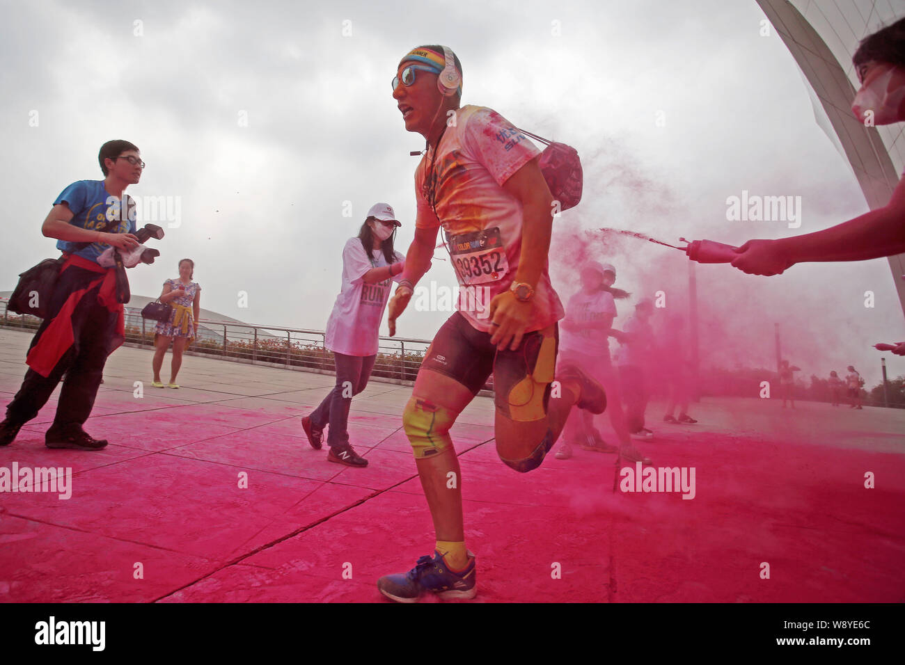 A participant is sprayed by a staff member with colored powder as he ...