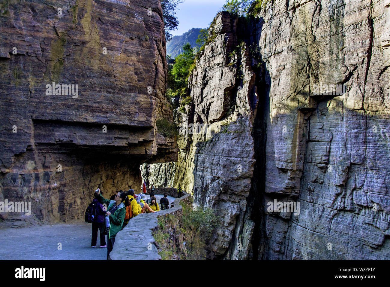 Tourists walk along the Guoliang Tunnel through the Wanxian Mountain in the Taihang Mountains in Huixian county, Xinxiang city, central China's Henan Stock Photo