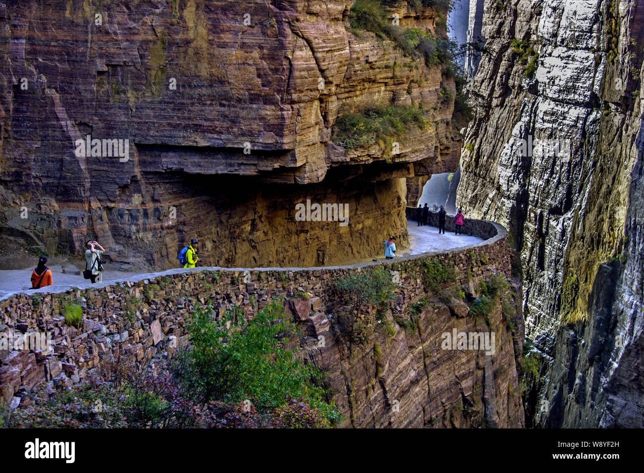 Tourists walk along the Guoliang Tunnel through the Wanxian Mountain in the Taihang Mountains in Huixian county, Xinxiang city, central China's Henan Stock Photo