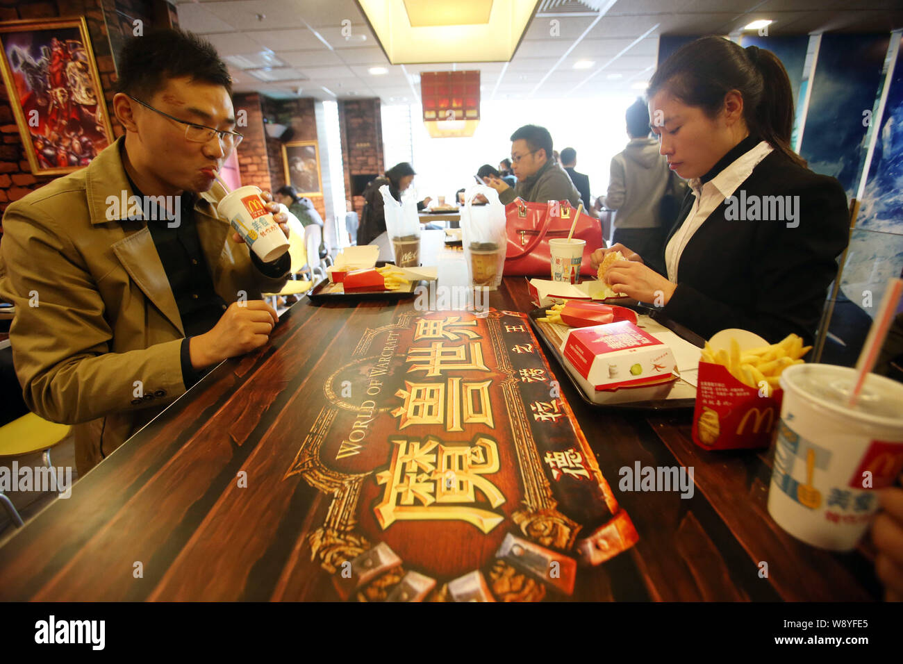 Customers eat food at a WorldofWarcraftthemed fastfood restaurant of McDonald