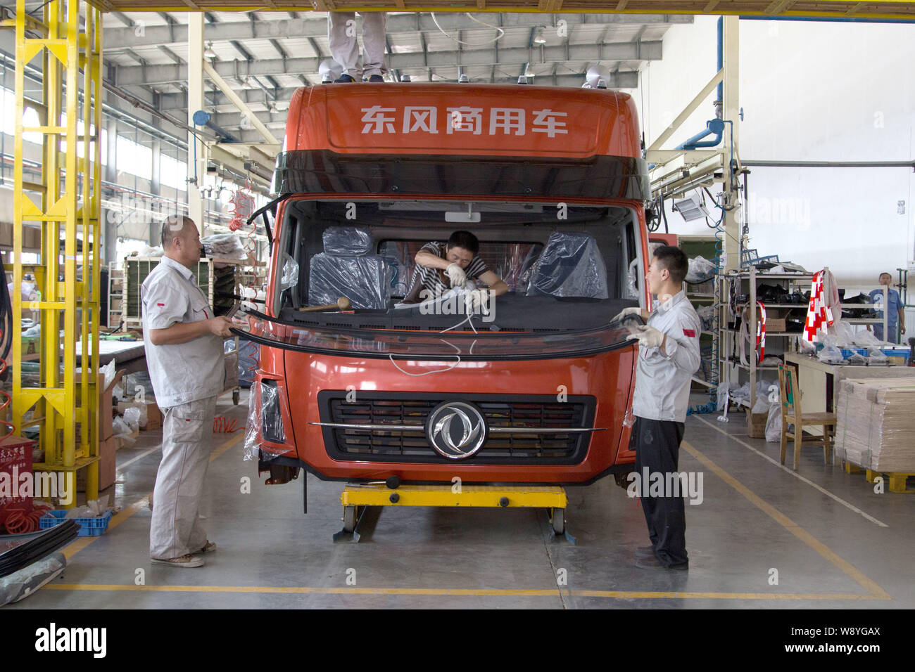 --FILE--Chinese workers assemble a truck on the assembly line at an ...