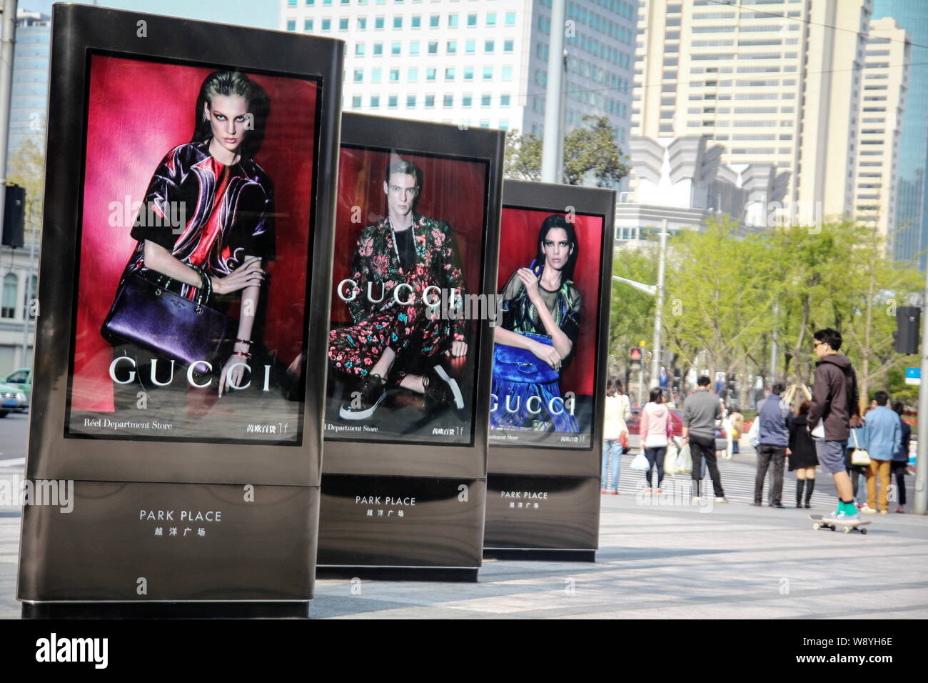 FILE--Pedestrians pass by advertisements of Gucci at Park Palace in  Shanghai, China, 7 April 2014. Gucci's new China chief has a tough task:  Make Stock Photo - Alamy