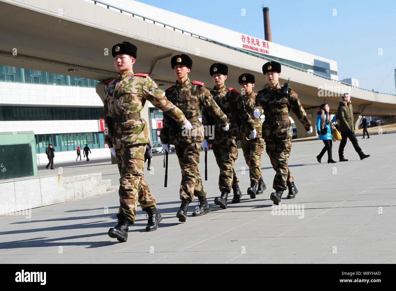 --FILE--Armed Chinese paramilitary policemen patrol the square in front of the Shenyang North Railway Station in Shenyang city, northeast Chinas Liaon Stock Photo