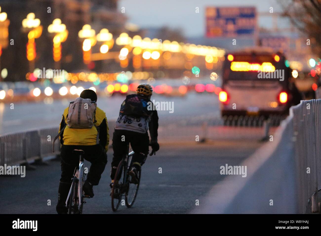--FILE--Local residents ride bicycles on a road in Beijing, China, 27 February 2014.   China has issued a behavioural standards guide to combat pollut Stock Photo