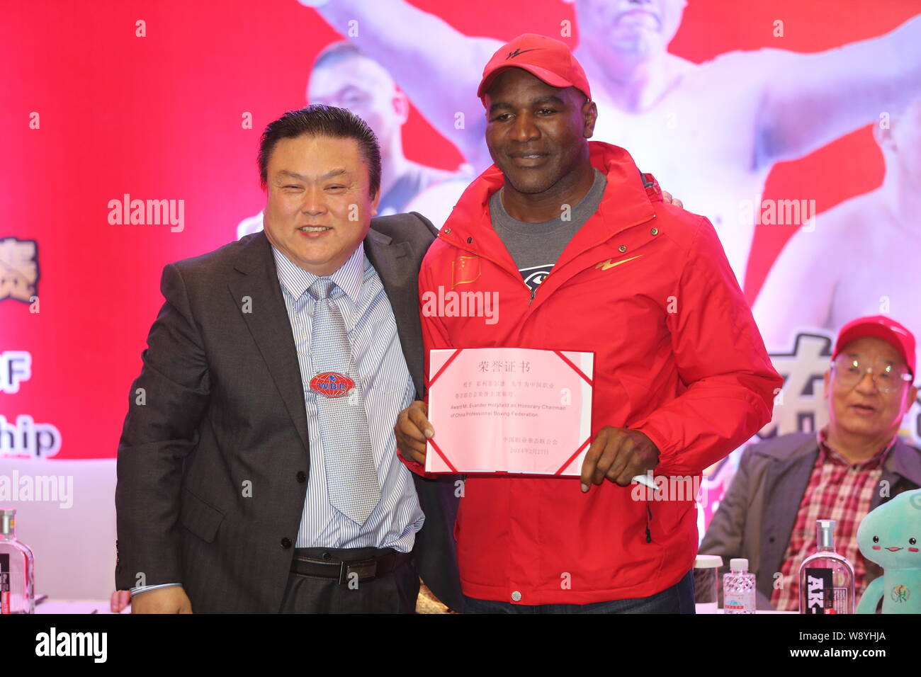 Retired U.S. boxer Evander Holyfield, right, poses with his certificate as he is appointed as Honorary Chairman of the China Professional Boxing Feder Stock Photo