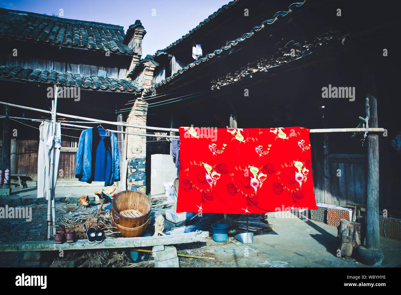 Local Chinese residents use bamboo poles to air out clothes in front of houses in Heishi Village, PanAn county, east Chinas Zhejiang province, 23 Nove Stock Photo