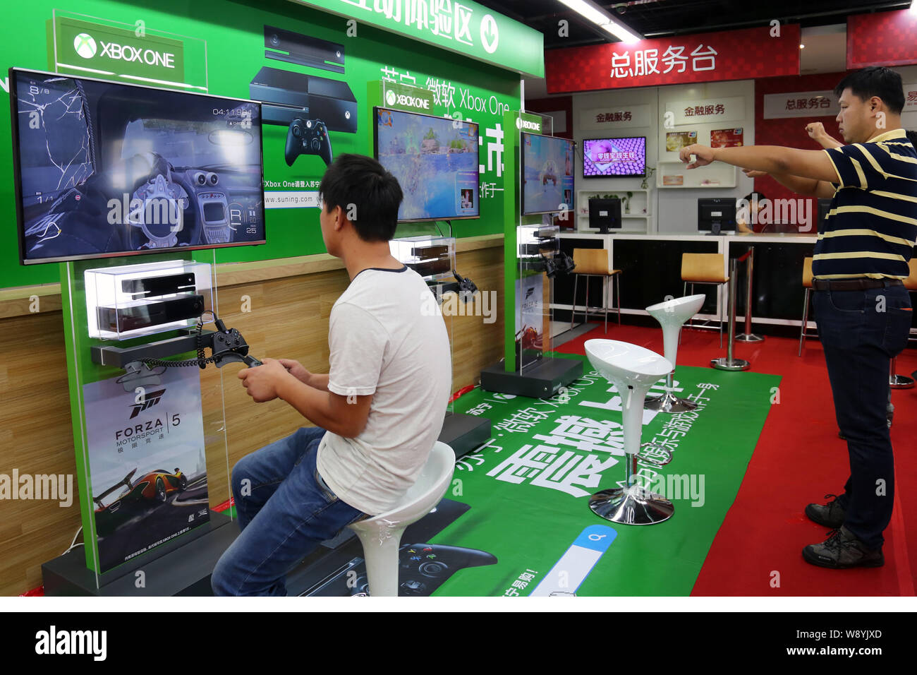 FILE--A young boy plays electronic games on an XBOX ONE game console at a  physical store of Microsoft in Shanghai, China, 26 December 2014. Produc  Stock Photo - Alamy