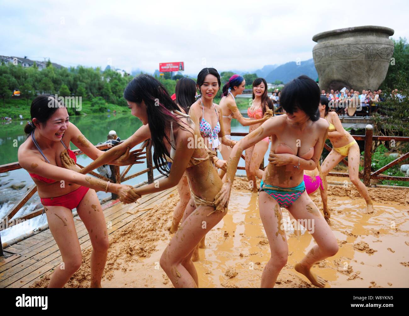 Bikini-dressed women have fun at a mud-wrestling event in a scenic area of Wulingyuan in Zhangjiajie city, central Chinas Hunan province, 10 September Stock Photo