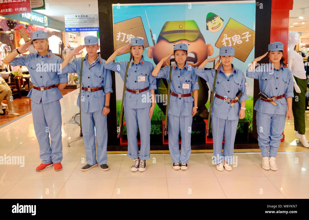 Chinese clerks dressed in blue uniforms of the Eighth Route Army salute  during a promotional campaign at a shopping mall in Taiyuan city, north  Chinas Stock Photo - Alamy