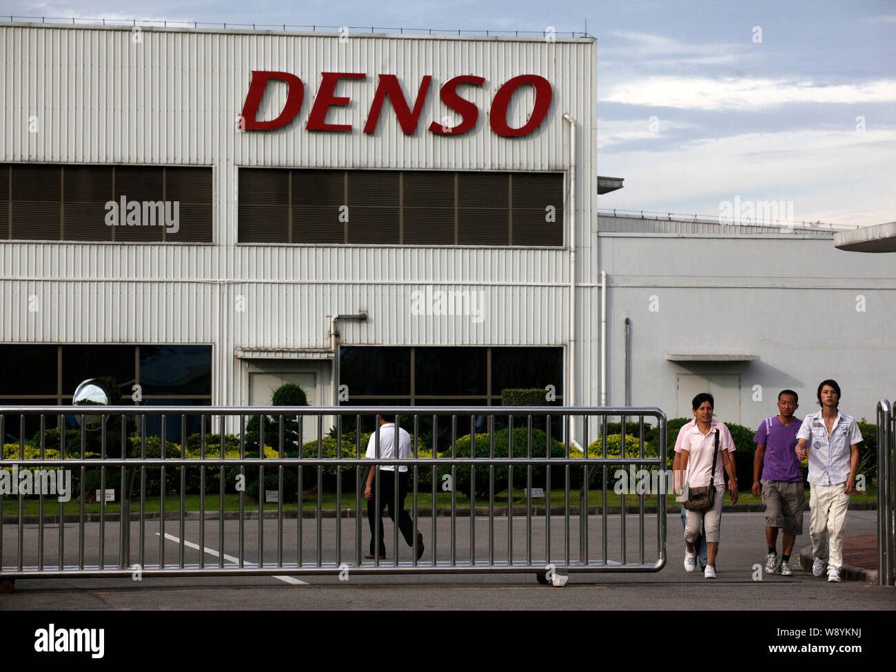 --FILE--Chinese workers leave the factory of Denso (Nansha) Co Ltd, an auto parts supplier of Toyota Motor, in Guangzhou city, south Chinas Guangdong Stock Photo