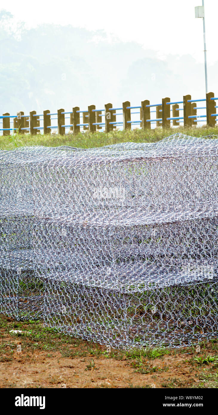 gabion : metal caged that filled with rocks or concretes for use in civil engineering, road building, military applications and landscaping Stock Photo