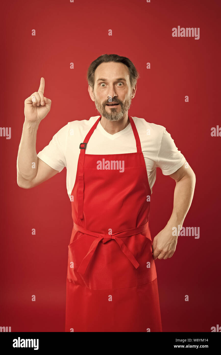 Something new. Cook with beard and mustache wearing apron red ...