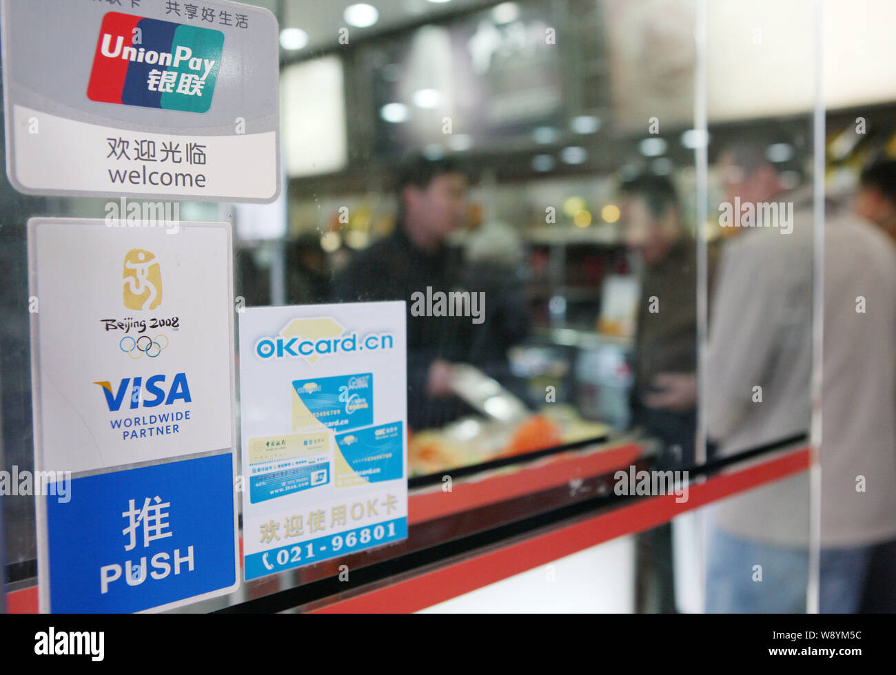 --FILE--Signs of China UnionPay and Visa are seen at a store in ...