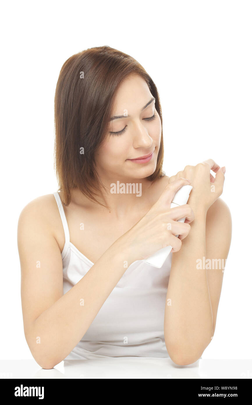 Woman applying moisturizer on her hand Stock Photo Alamy