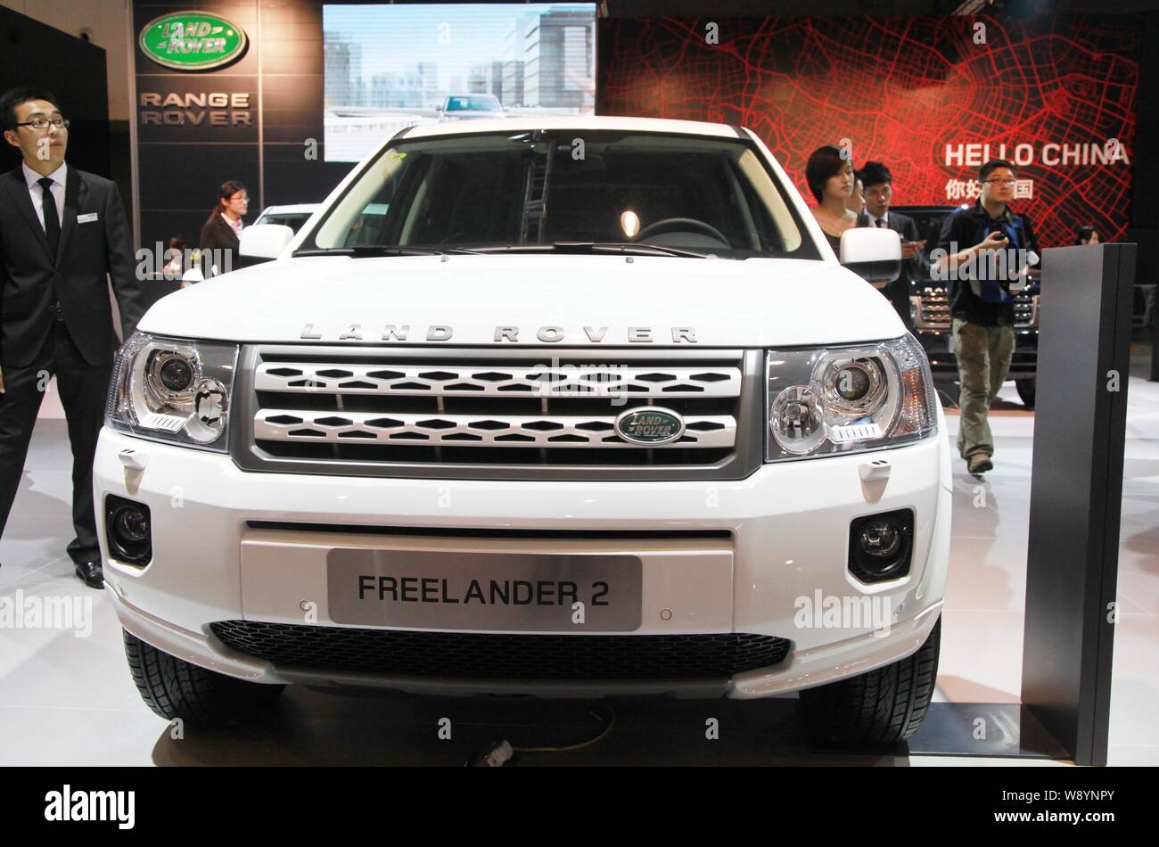 --FILE--Visitors walk past a Land Rover Freelander 2 SUV during an automobile exhibition in Nanjing city, east Chinas Jiangsu province, 29 September 2 Stock Photo