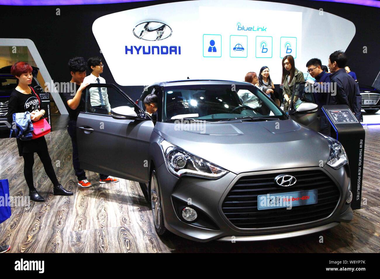 --FILE--Visitors look at or try out a Hyundai Veloster Turbo-GDi during an automobile exhibition in Tianjin, China, 3 October 2014.   Hyundai Motor Co Stock Photo
