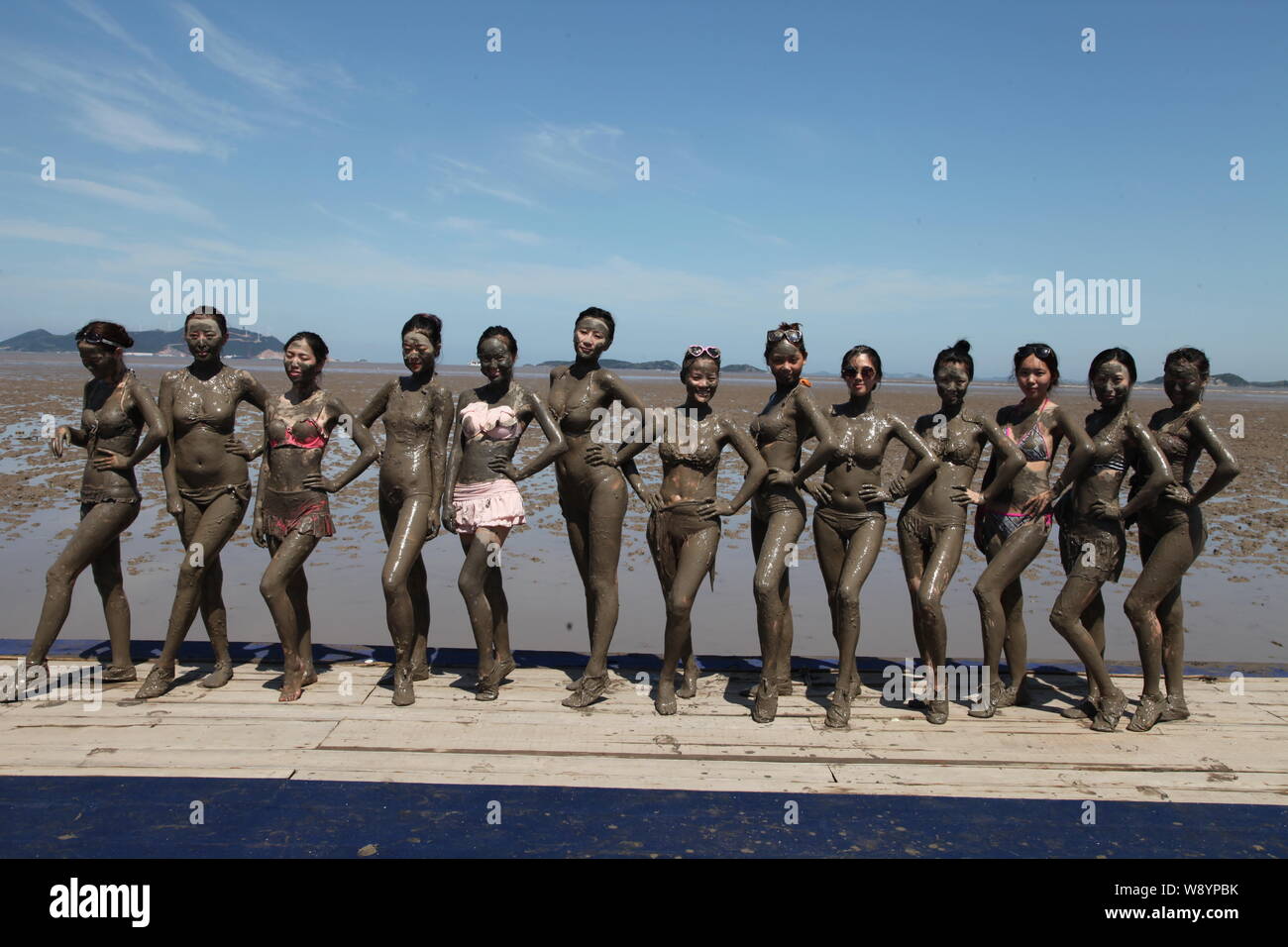 Young Chinese models who get muddy all over pose in line on a tidal flat on  the Xiushan Island in Daishan county, Zhoushan city, east Chinas Zhejiang  Stock Photo - Alamy