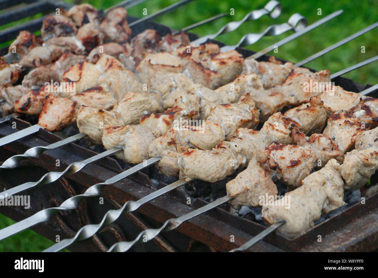 Cooking barbecue skewers. Marinated kebab is grilled on charcoal. Shish