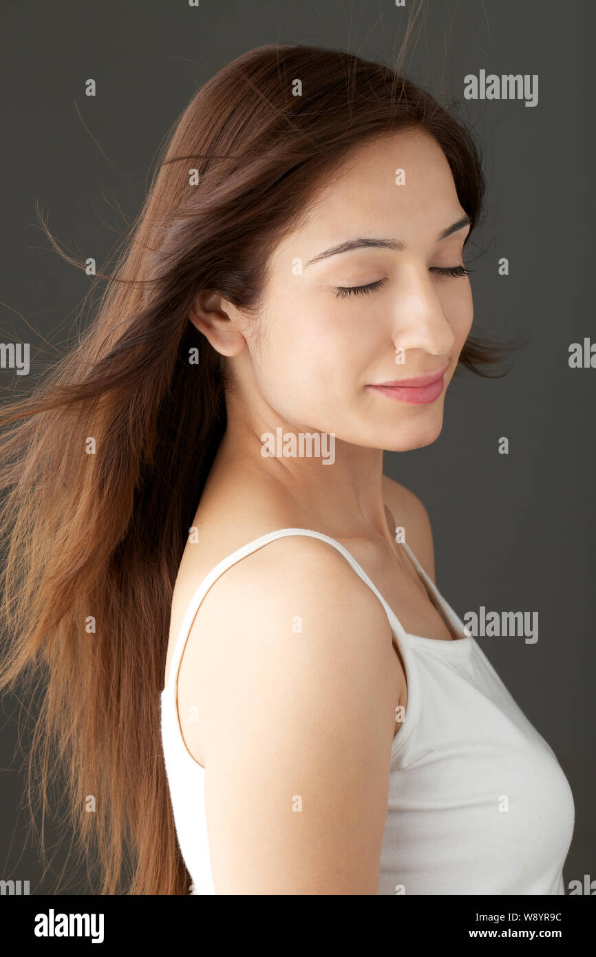 Close up of a woman with hair blowing in wind Stock Photo