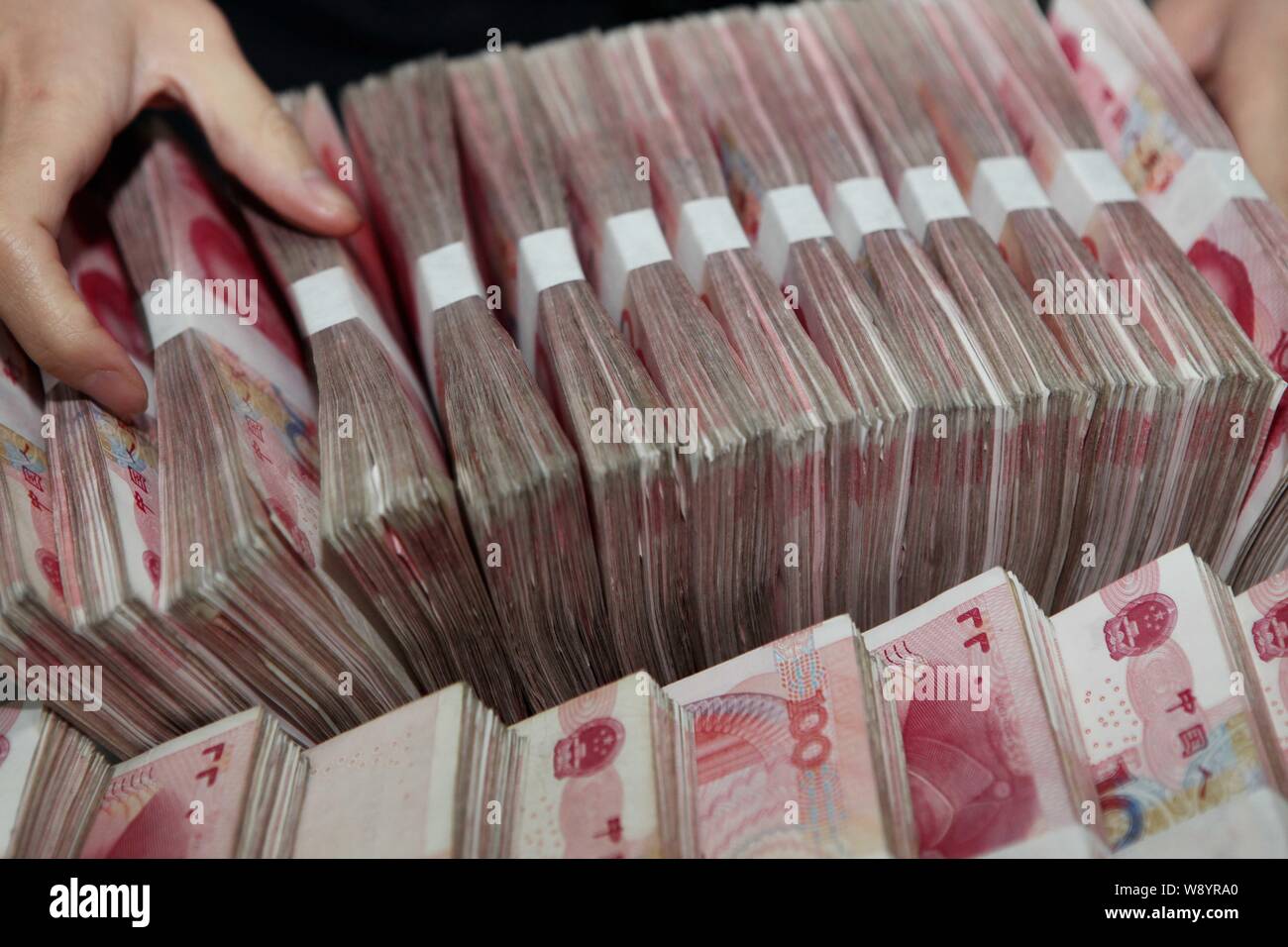 Counting Rmb --FILE--A Chinese clerk counts RMB (renminbi) yuan banknotes at a bank ...