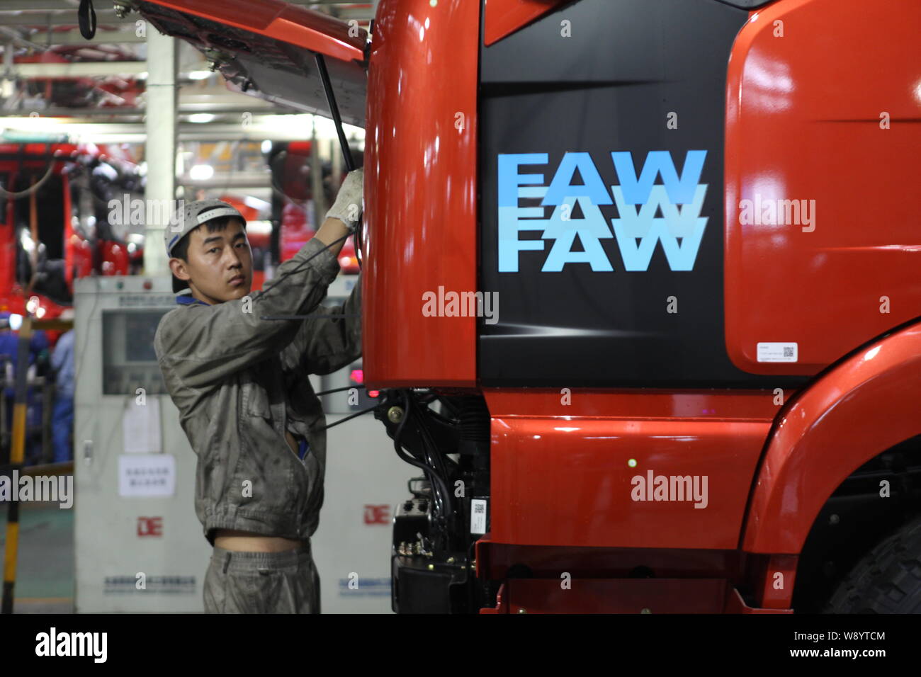 --FILE--A Chinese worker assembles a FAW truck on the assembly line at ...