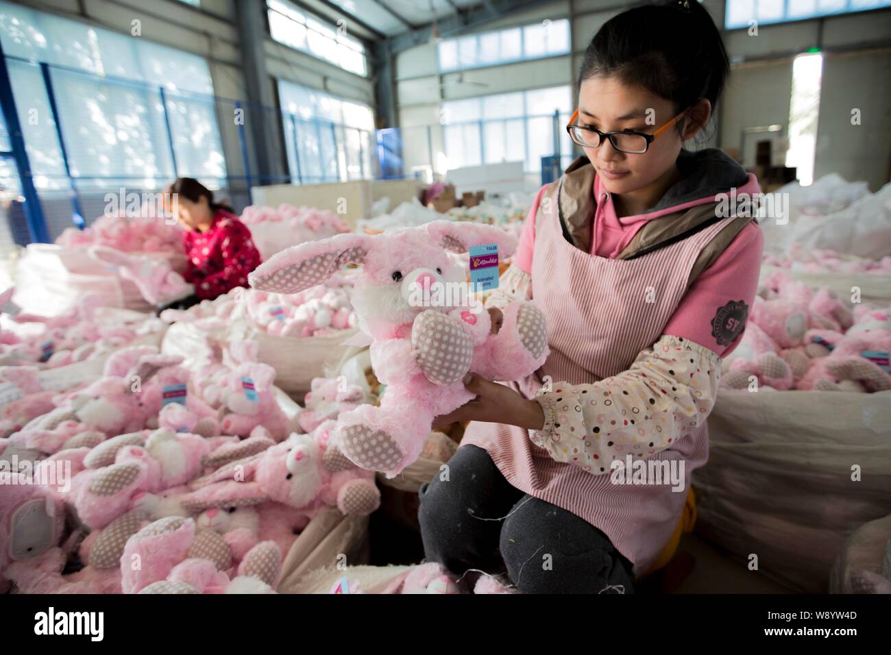 --FILE--Female Chinese workers sew stuffed toys to be exported to Europe and the United States at a garment factory in Ganyu Economic Development Area Stock Photo