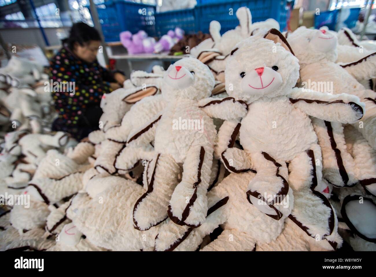--FILE--A female Chinese worker sews stuffed toys to be exported to Europe and the United States at a garment factory in Ganyu Economic Development Ar Stock Photo