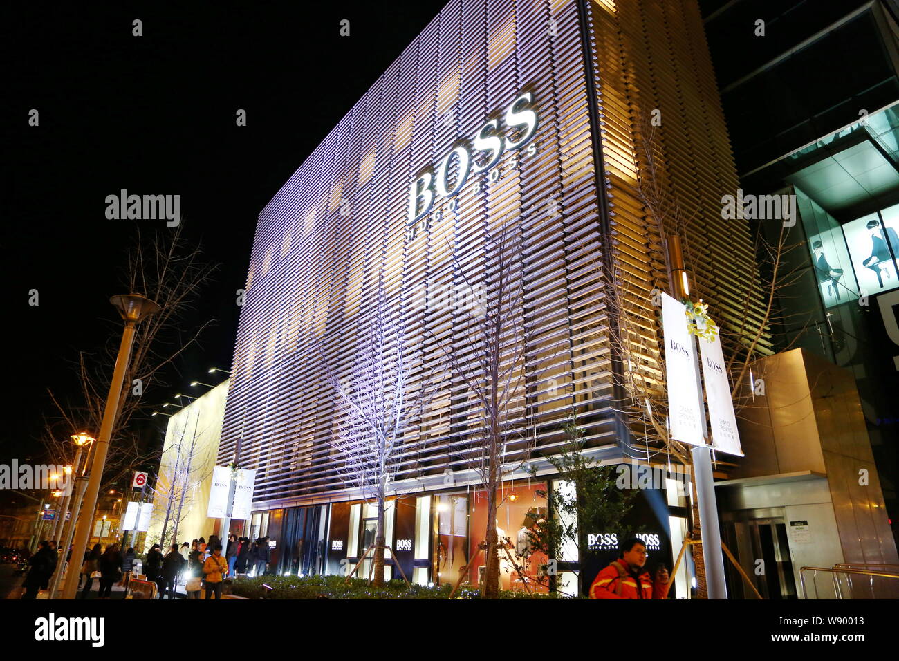 FILE--Pedestrians walk past the flagship store of Hugo Boss at Jing An  Kerry Centre in Shanghai, China, 15 January 2014. German fashion house Hugo  Stock Photo - Alamy