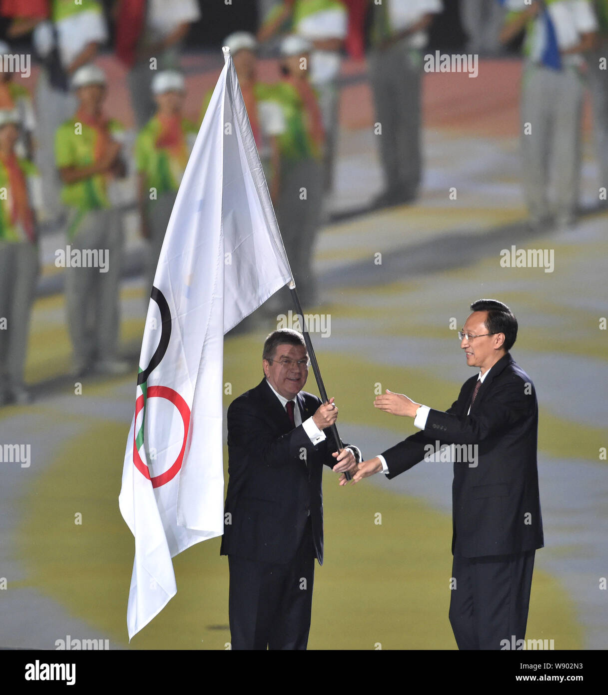 Thomas Bach, left, President of the International Olympic Committee (IOC), delivers the Olympic flag to Li Xueyong, President of the Nanjing Youth Oly Stock Photo