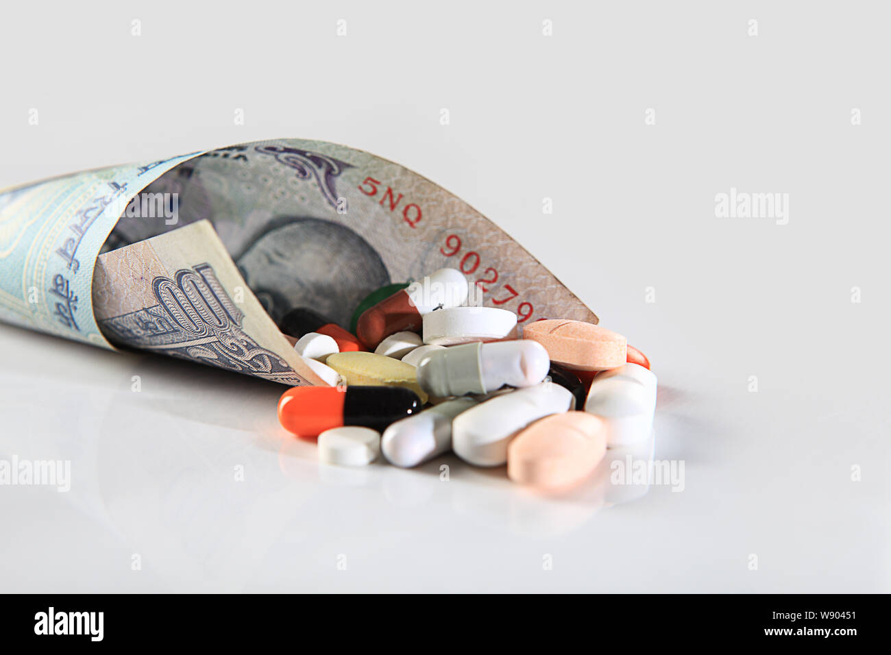 Pills with Indian currency Stock Photo