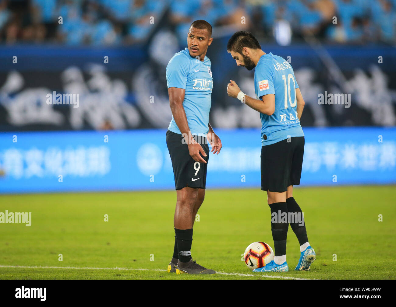Belgian football player Yannick Ferreira Carrasco of Dalian Yifang F.C.,  right, talks with Venezuelan football player Salomon Rondon of Dalian  Yifang F.C., left, during the 23th round of Chinese Football Association  Super