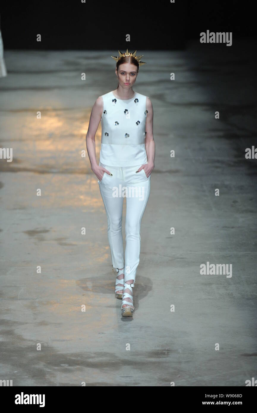 A model displays a new creation by designer Liu Sicong at the C ...
