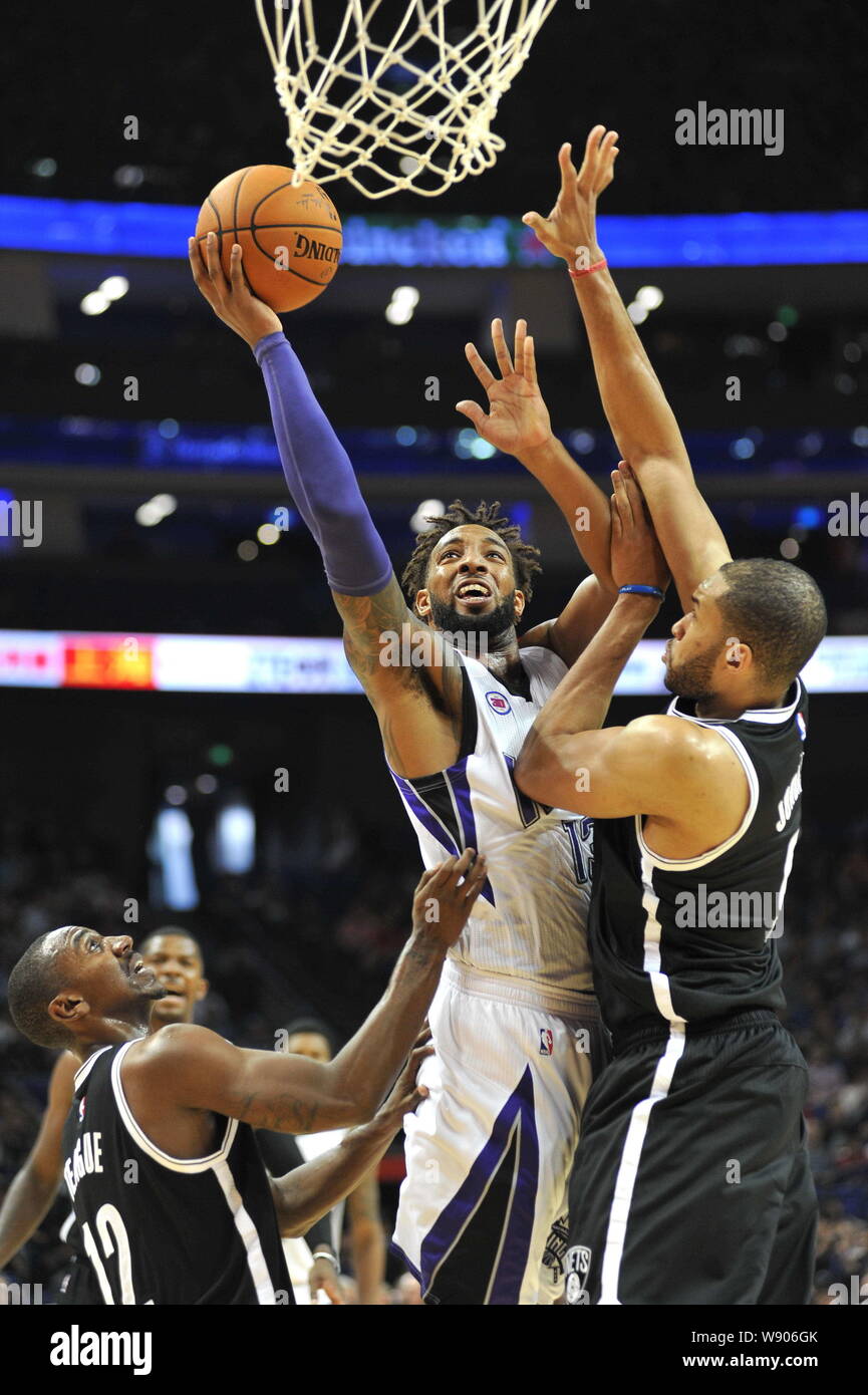 Jerome Jordan of Brooklyn Nets, right, tries to block a shot by Derrick Williams of Sacramento Kings during an NBA exhibition game in Shanghai, China, Stock Photo