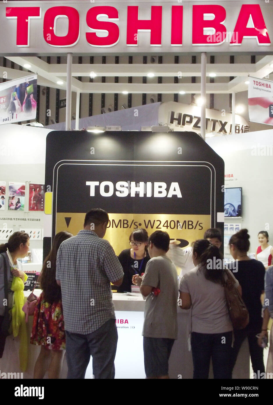 --FILE--People visit the stand of Toshiba during an exhibition in Nanjing city, east Chinas Jiangsu province, 19 July 2014.   Toshiba will recall 531, Stock Photo