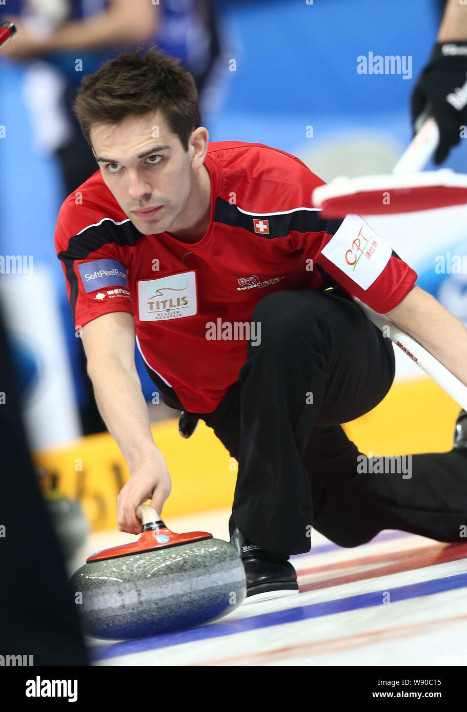 Peter de Cruz of Switzerland releases a stone against Sweden in their