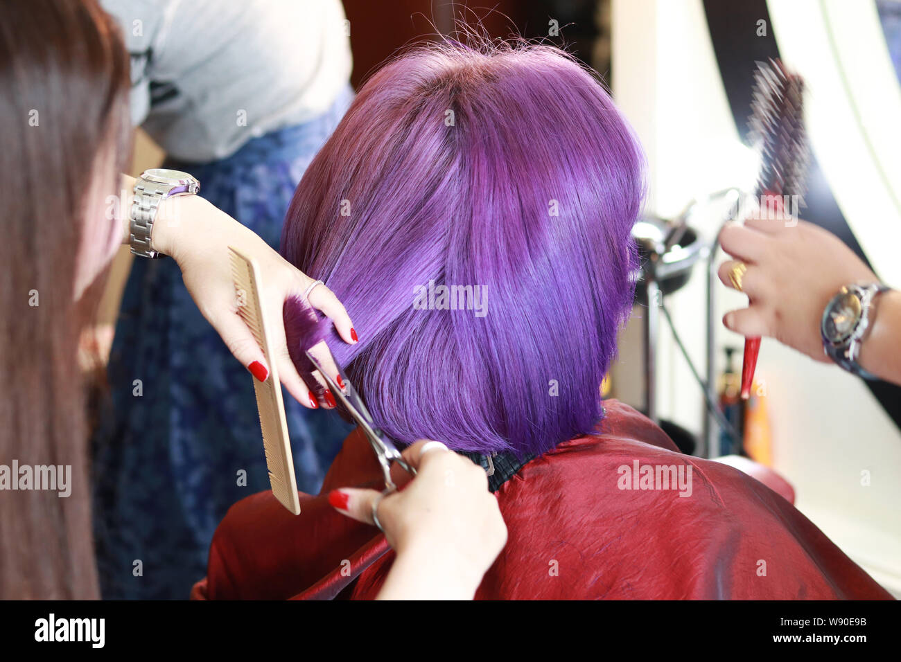 The Hairdresser Used A Hair Trimming Scissors Cutting On The Hair
