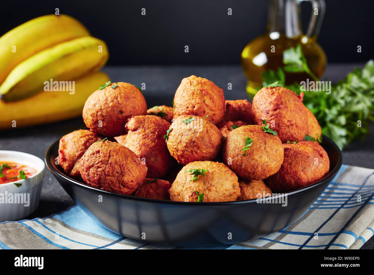 closeup of deep fried banana croquettes Klako in a black bowl with