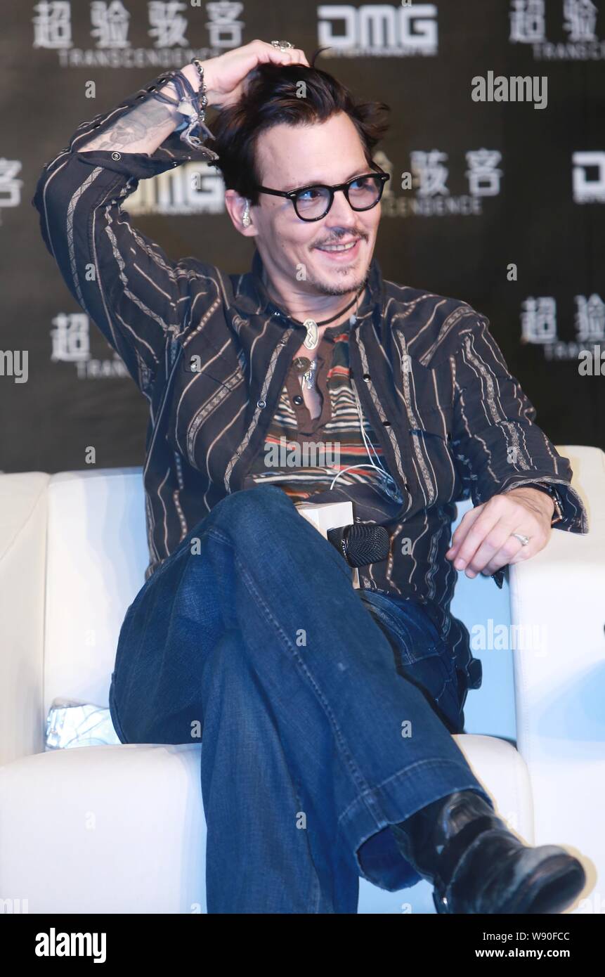 American actor Johnny Depp smiles at a press conference for his movie, Transcendence, in Beijing, China, 31 March 2014. Stock Photo