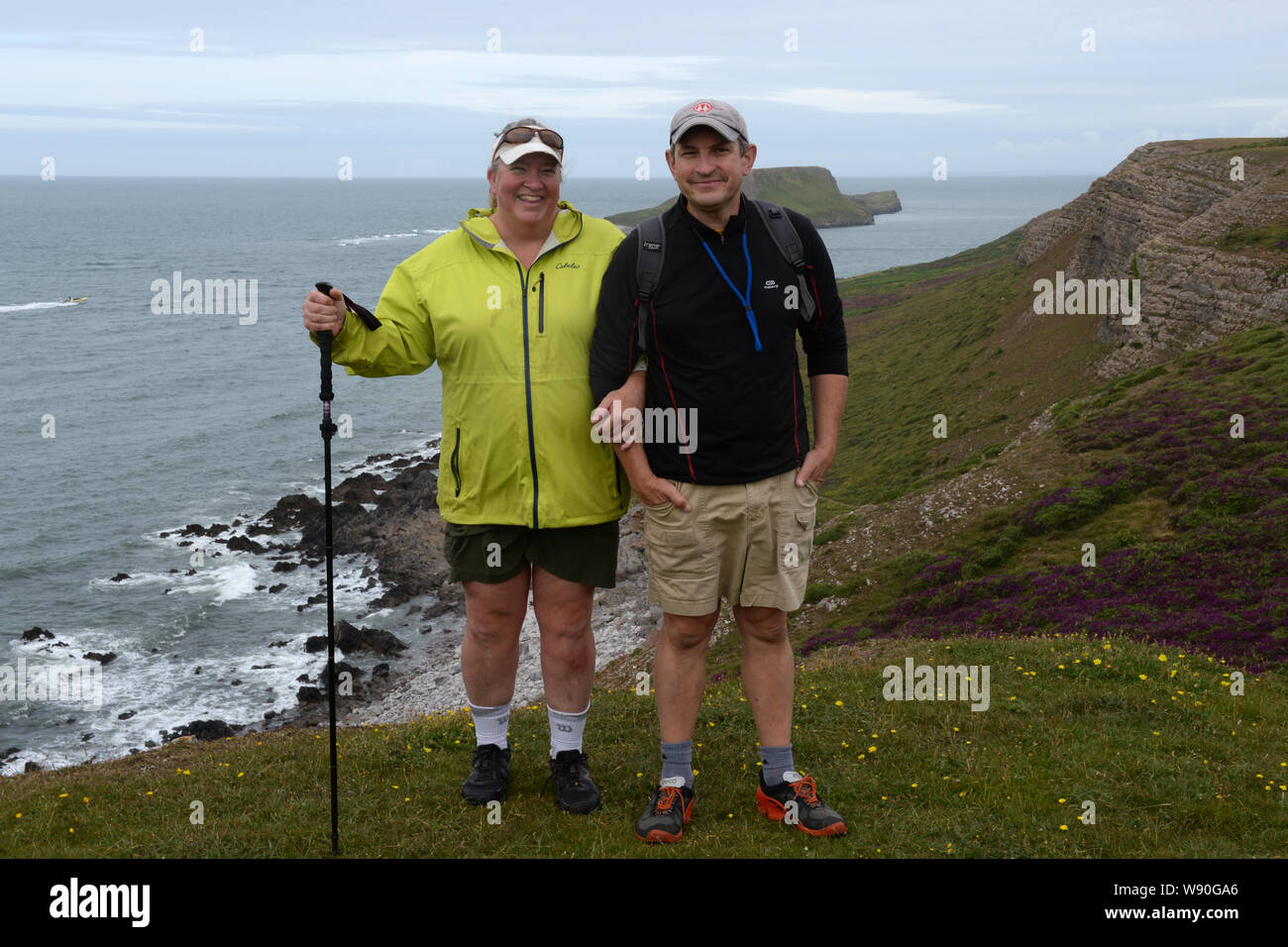 Walkers pause for a photograph on the cliff path to Rhossili and Worms Head Stock Photo