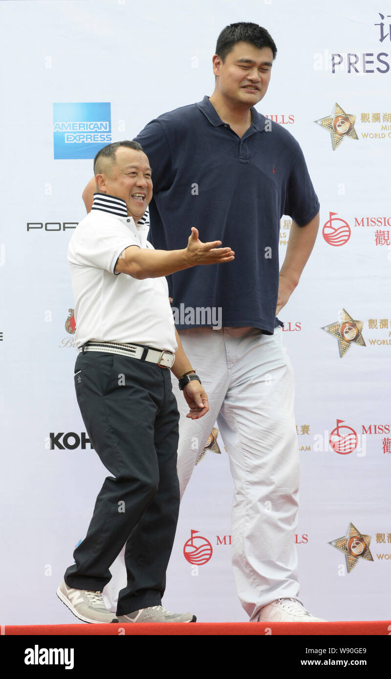 Retired Chinese basketball star Yao Ming, right, and Hong Kong actor Eric Tsang attend a press conference for the 2014 Mission Hills World Celebrity P Stock Photo