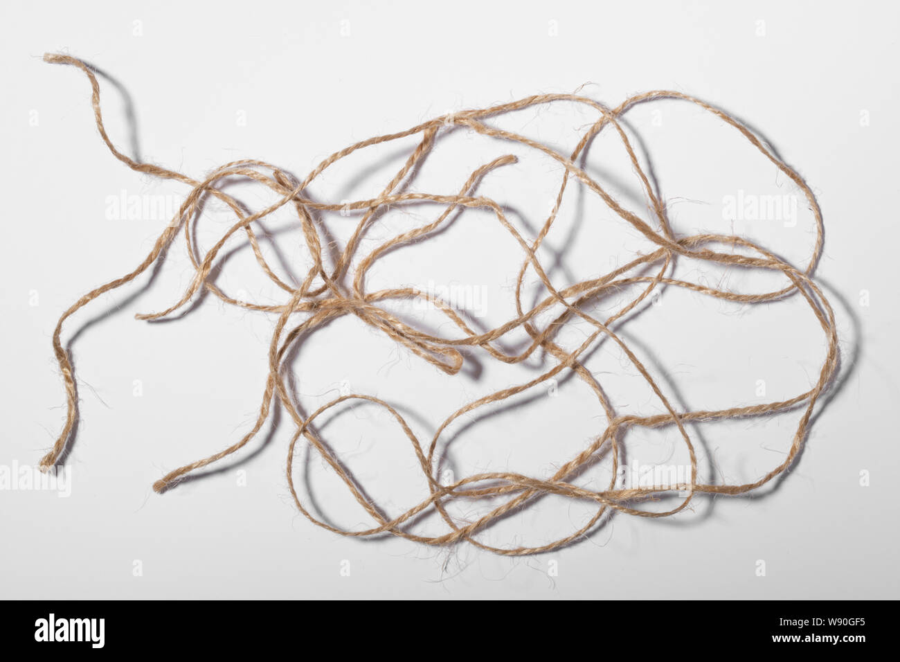 Several pieces of brown string on a white background Stock Photo